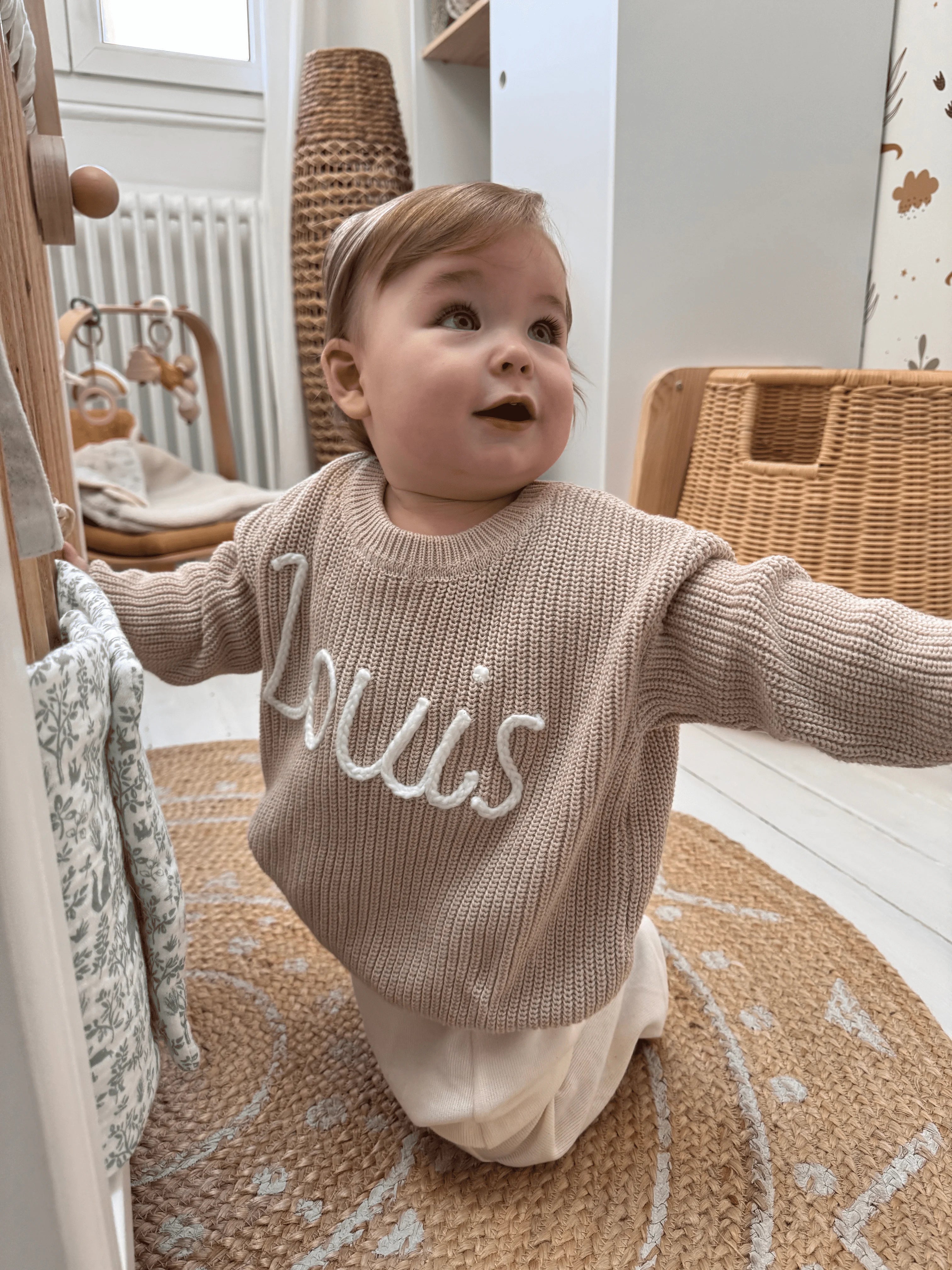 Hand-knitted embroidered baby sweater